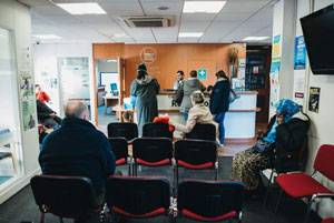 a photograph of customers waiting inside a Citizen's Advice branch